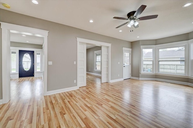 unfurnished living room featuring ceiling fan and light hardwood / wood-style floors