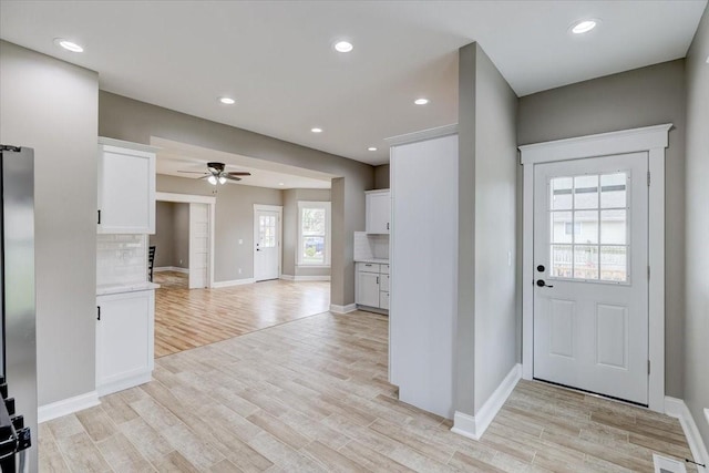 entrance foyer with ceiling fan and light wood-type flooring