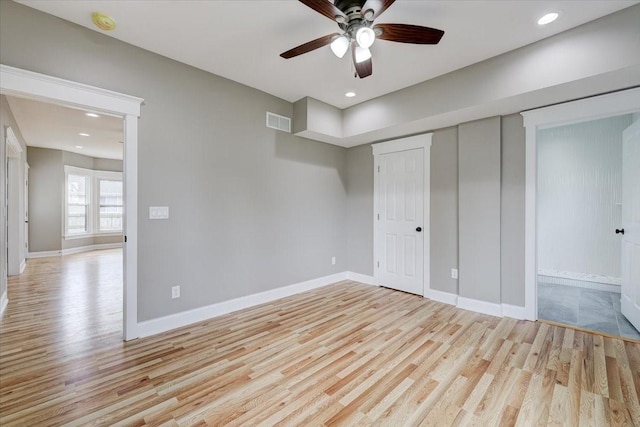 unfurnished bedroom with ceiling fan, a closet, and light hardwood / wood-style flooring