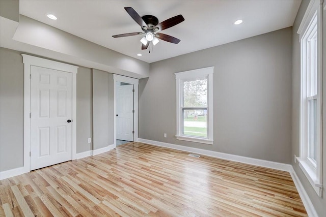 unfurnished bedroom with a closet, light hardwood / wood-style floors, and ceiling fan