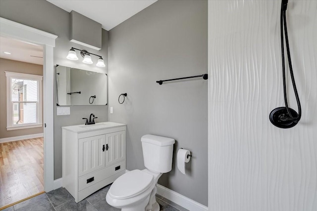 bathroom featuring hardwood / wood-style floors, vanity, and toilet