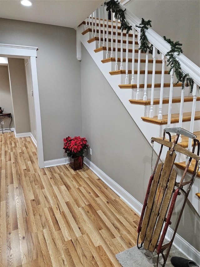 stairs with hardwood / wood-style flooring