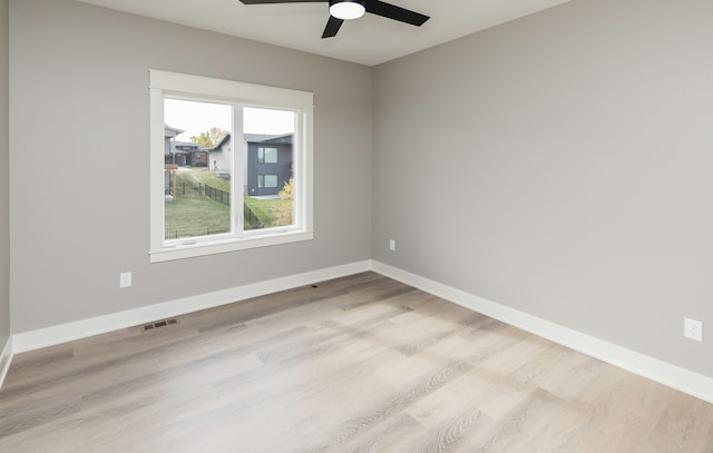 spare room featuring light hardwood / wood-style flooring and ceiling fan