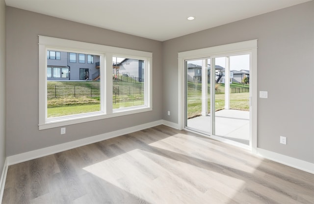 unfurnished room with light hardwood / wood-style floors