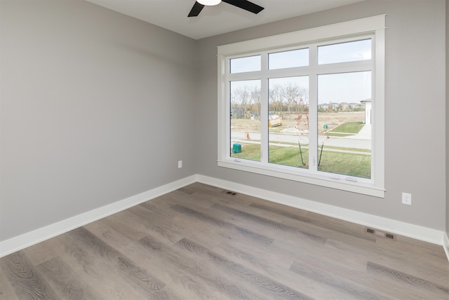 spare room featuring ceiling fan and hardwood / wood-style flooring