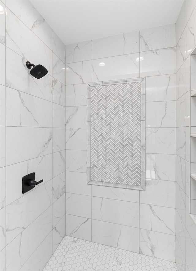 bathroom with a tile shower