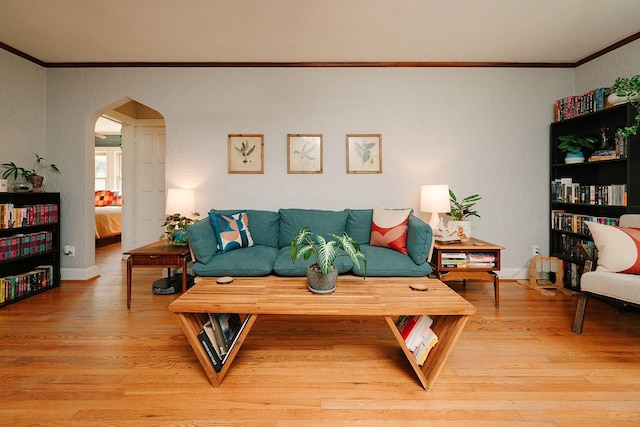 living room featuring wood-type flooring and ornamental molding