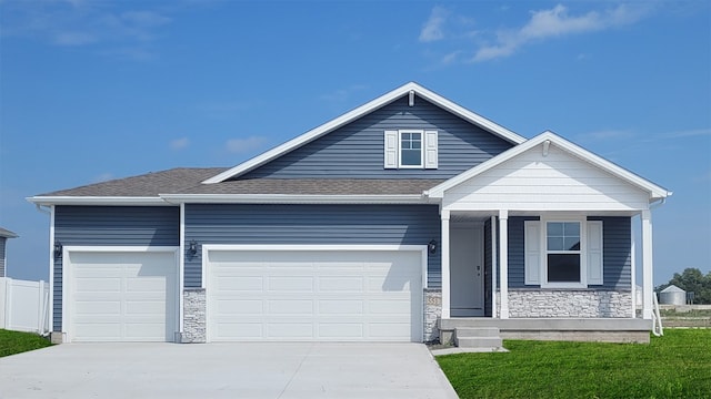 view of front of property featuring a front lawn and a garage