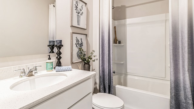 full bathroom featuring shower / bath combo, vanity, and toilet