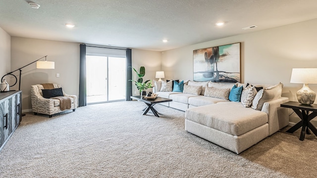 living room with carpet floors and a textured ceiling