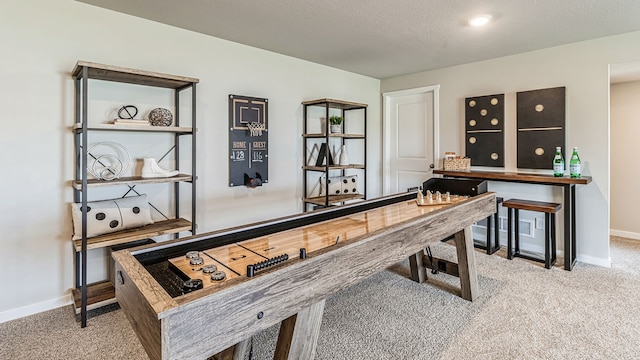 recreation room featuring carpet flooring and a textured ceiling