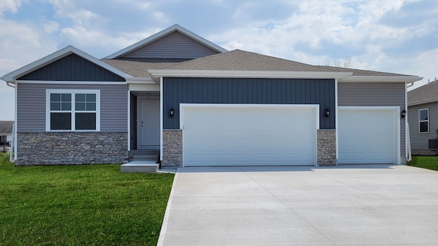 view of front of house with a garage and a front lawn