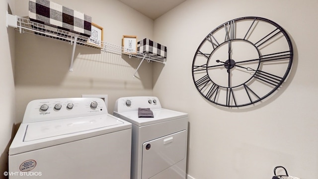 clothes washing area featuring washer and dryer