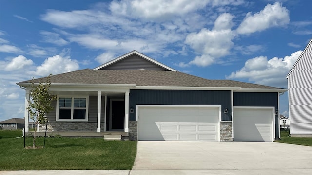 view of front facade featuring a front yard, a porch, and a garage