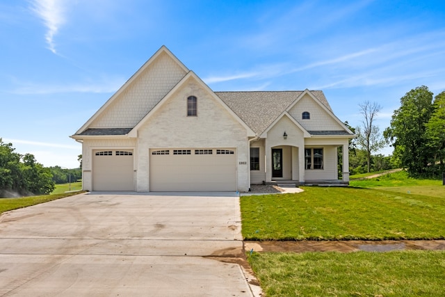 view of front of property with a front lawn and a garage