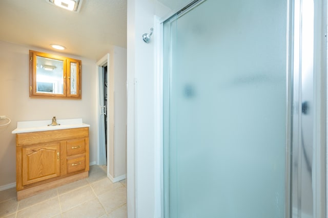 bathroom with tile patterned flooring, vanity, and an enclosed shower