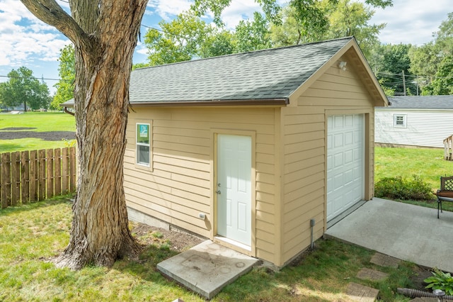 view of outdoor structure with a lawn and a garage