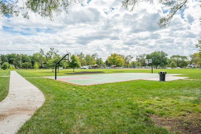 view of basketball court with a yard