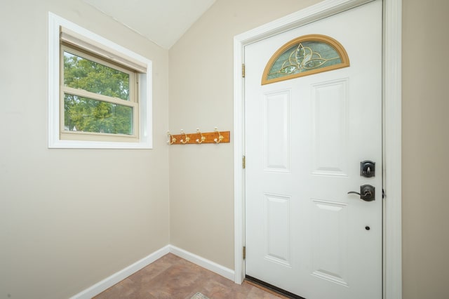 doorway to outside featuring lofted ceiling