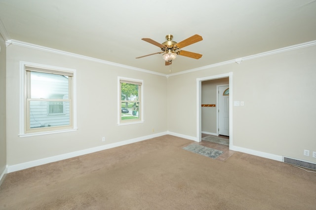 carpeted empty room with ornamental molding and ceiling fan