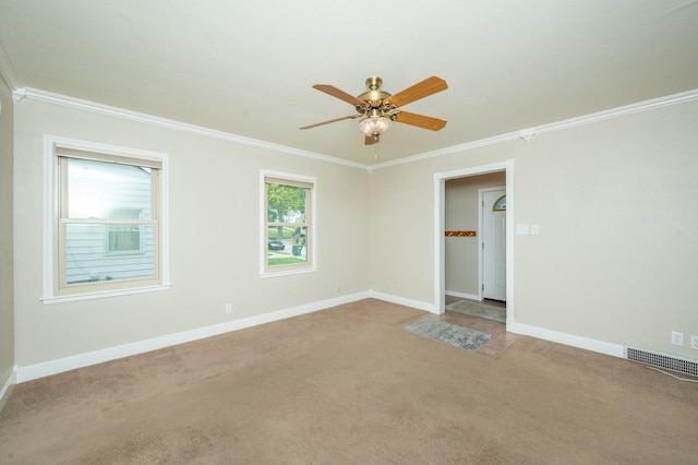 unfurnished room with visible vents, light carpet, baseboards, and ornamental molding