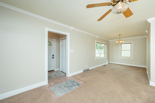 carpeted empty room featuring ceiling fan with notable chandelier and ornamental molding