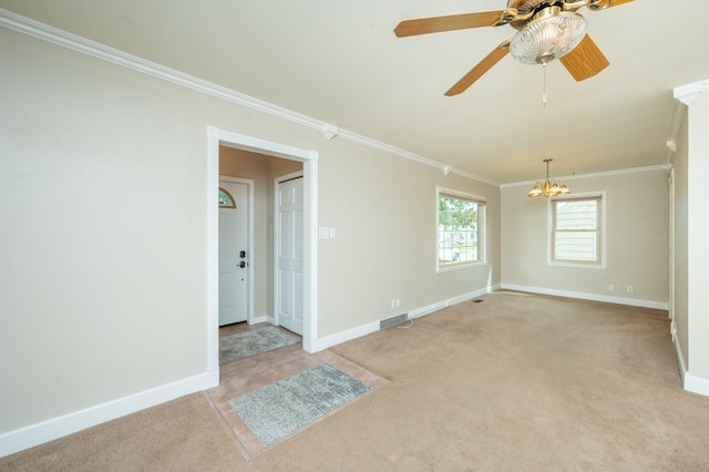 empty room featuring baseboards, visible vents, ornamental molding, ceiling fan with notable chandelier, and light colored carpet