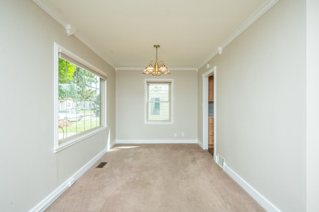 empty room featuring visible vents, a notable chandelier, crown molding, baseboards, and light colored carpet