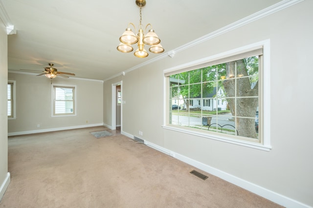 spare room featuring carpet floors, ceiling fan with notable chandelier, and ornamental molding