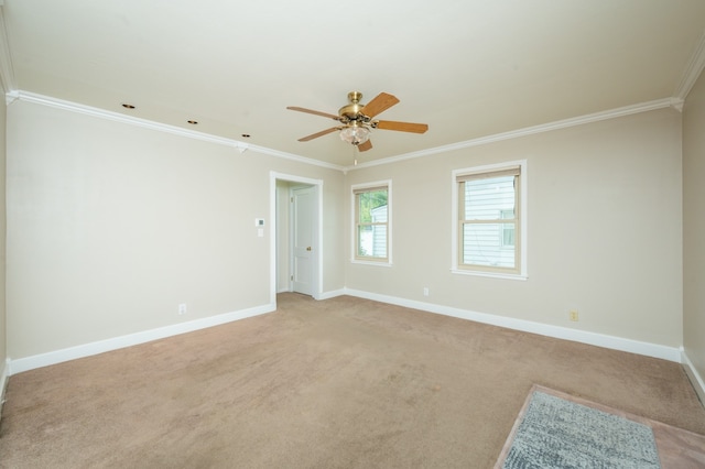 carpeted spare room featuring ornamental molding and ceiling fan