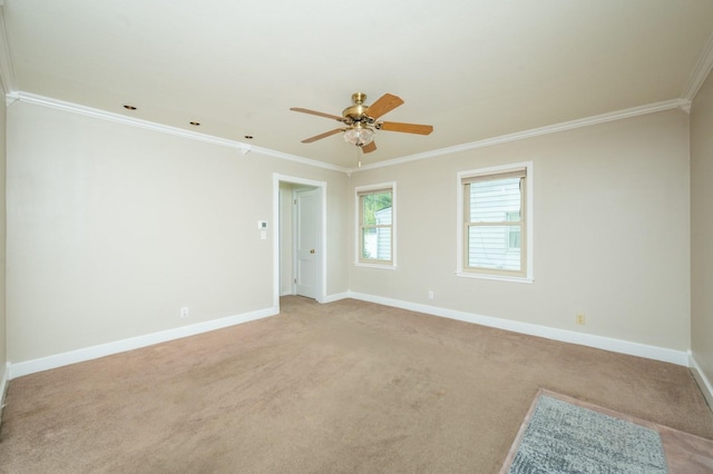 unfurnished room featuring ceiling fan, light carpet, baseboards, and ornamental molding