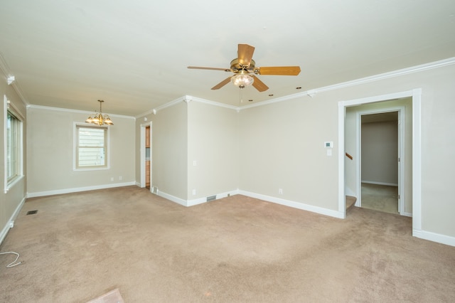 spare room featuring light carpet, ceiling fan with notable chandelier, and crown molding