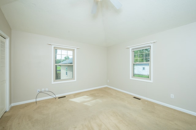 unfurnished room with ceiling fan and light colored carpet