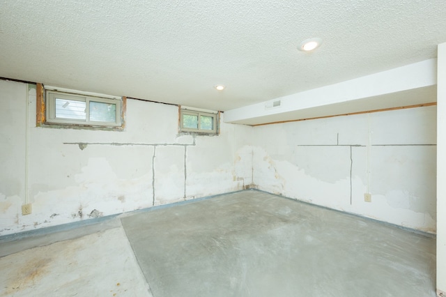 basement featuring a textured ceiling