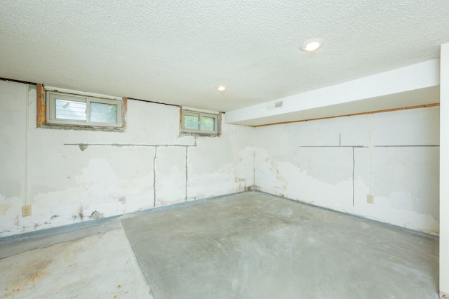 basement with visible vents and a textured ceiling