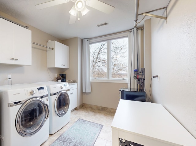 laundry room featuring light tile patterned floors, washing machine and dryer, ceiling fan, and cabinets