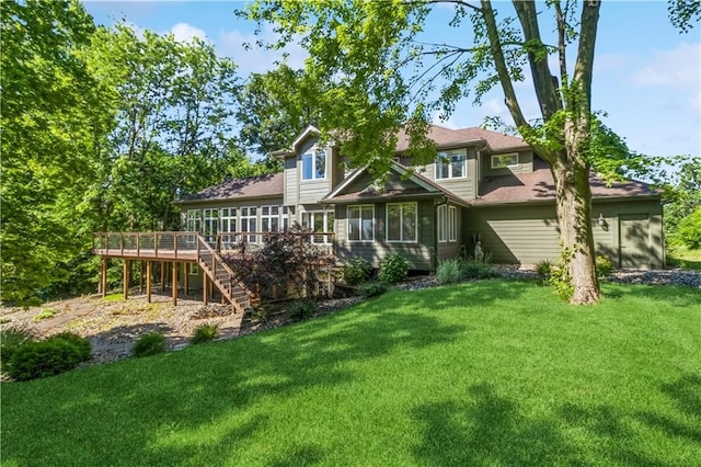 back of house featuring a lawn, a sunroom, and a deck