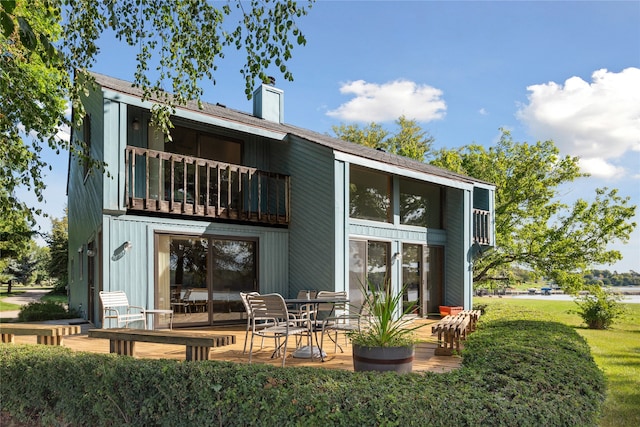 back of property with a balcony and a patio area