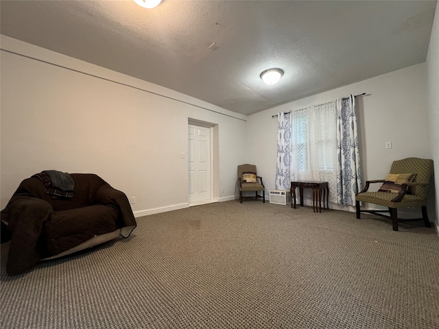 living area with a textured ceiling and dark colored carpet