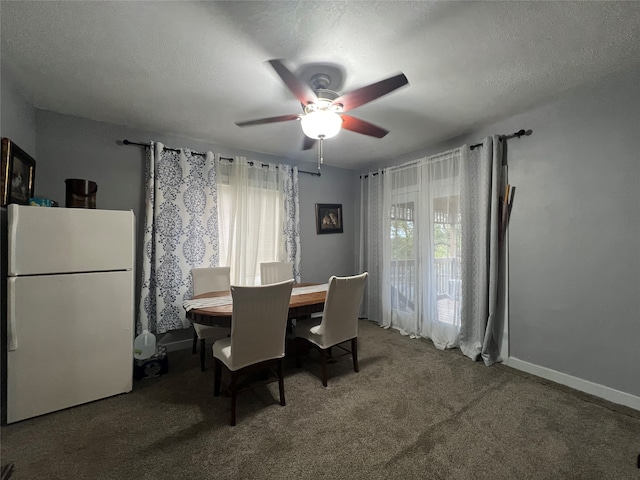 dining space with a textured ceiling, carpet floors, ceiling fan, and a wealth of natural light