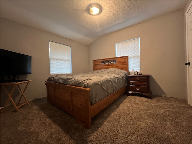 carpeted bedroom with a textured ceiling and lofted ceiling