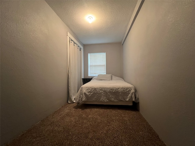 carpeted bedroom with a textured ceiling