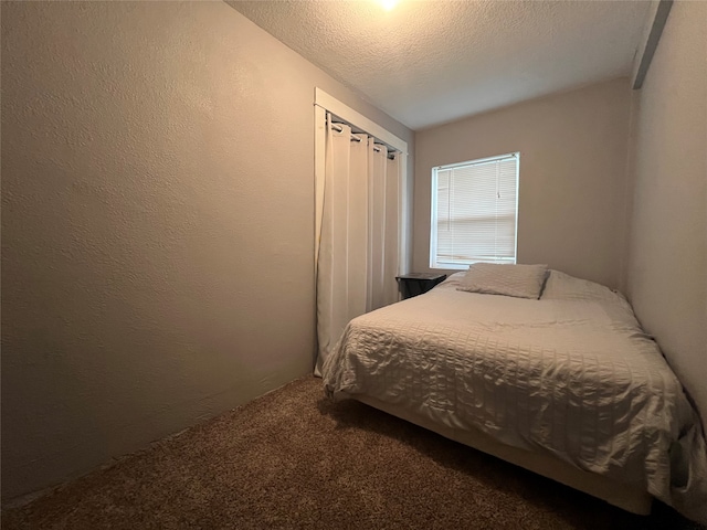 bedroom with a textured ceiling and carpet