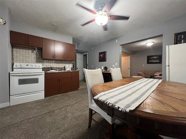 kitchen with ceiling fan, carpet flooring, white appliances, a textured ceiling, and backsplash