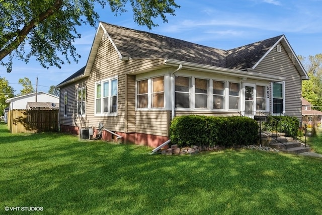 view of property exterior with cooling unit and a lawn