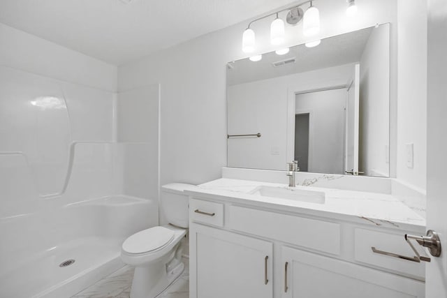 bathroom with a shower, vanity, and toilet