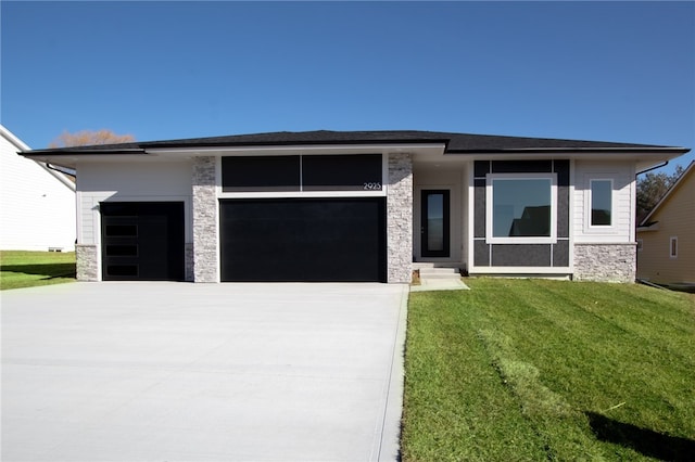 prairie-style house featuring a front yard and a garage