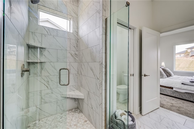 bathroom featuring walk in shower, toilet, and a wealth of natural light