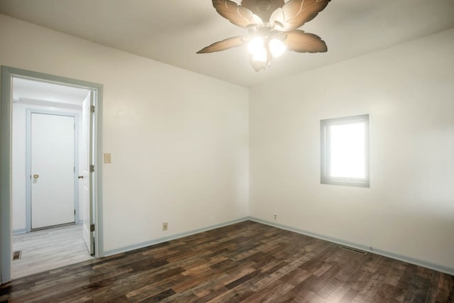 empty room with ceiling fan and dark wood-type flooring