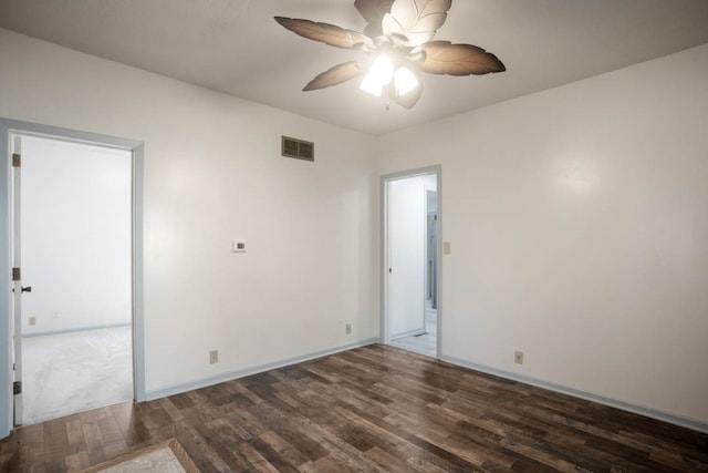 empty room with dark wood-type flooring and ceiling fan